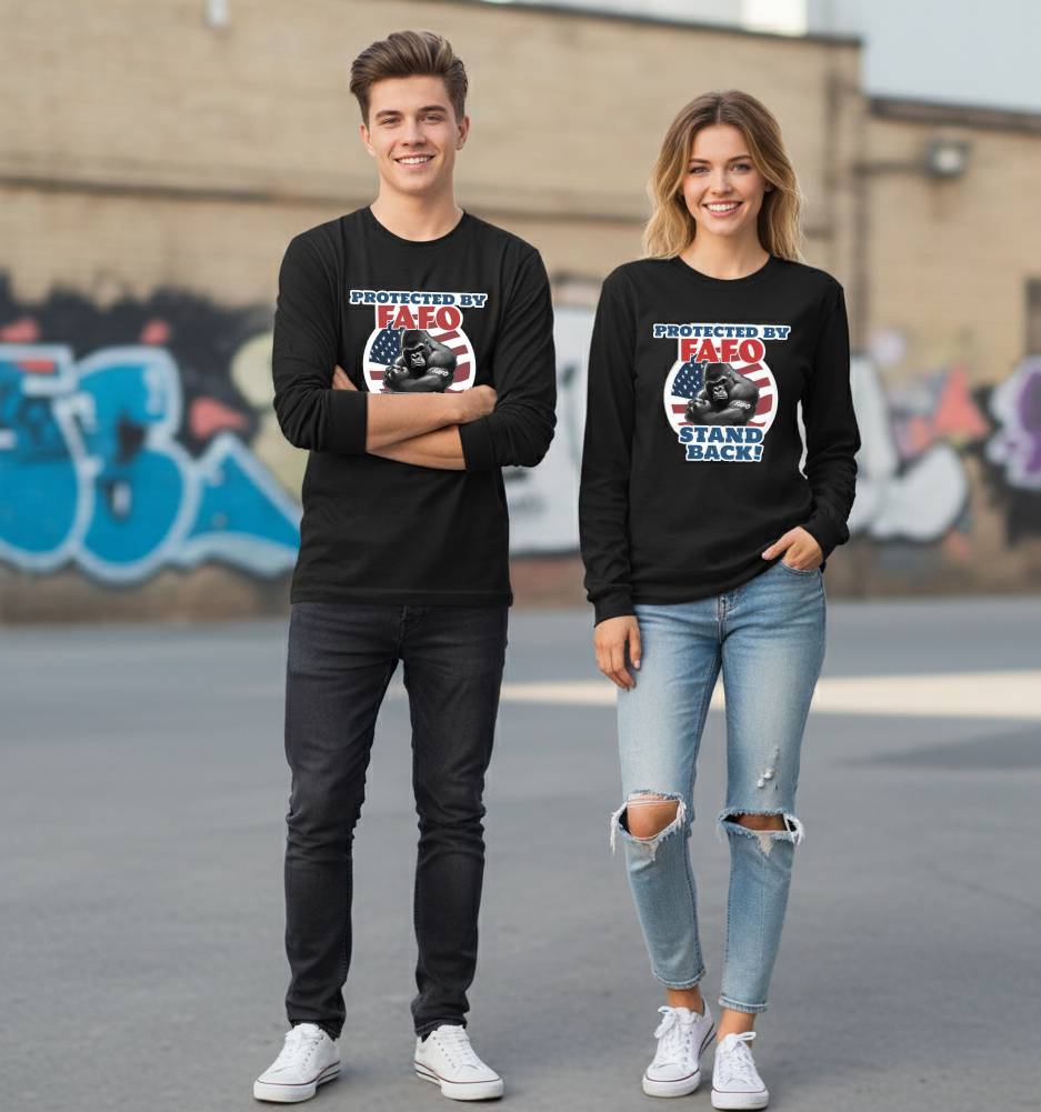 Two people wearing black sweatshirts with a graphic design in an urban setting.